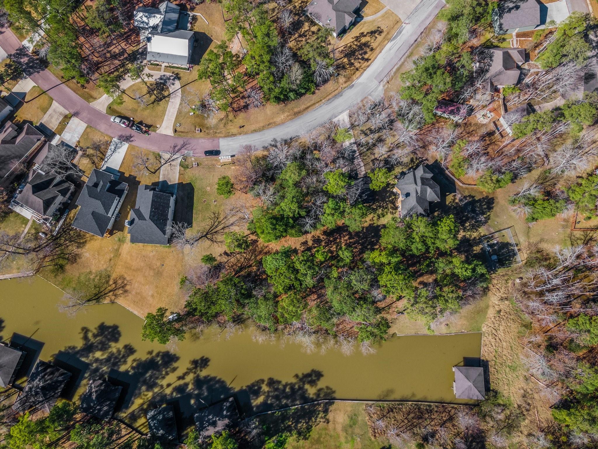Image 2: This wooded waterfront lot is 0.39 acres - plans i