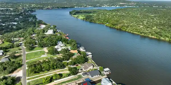 Image 2: This photo shows a serene riverside neighborhood w