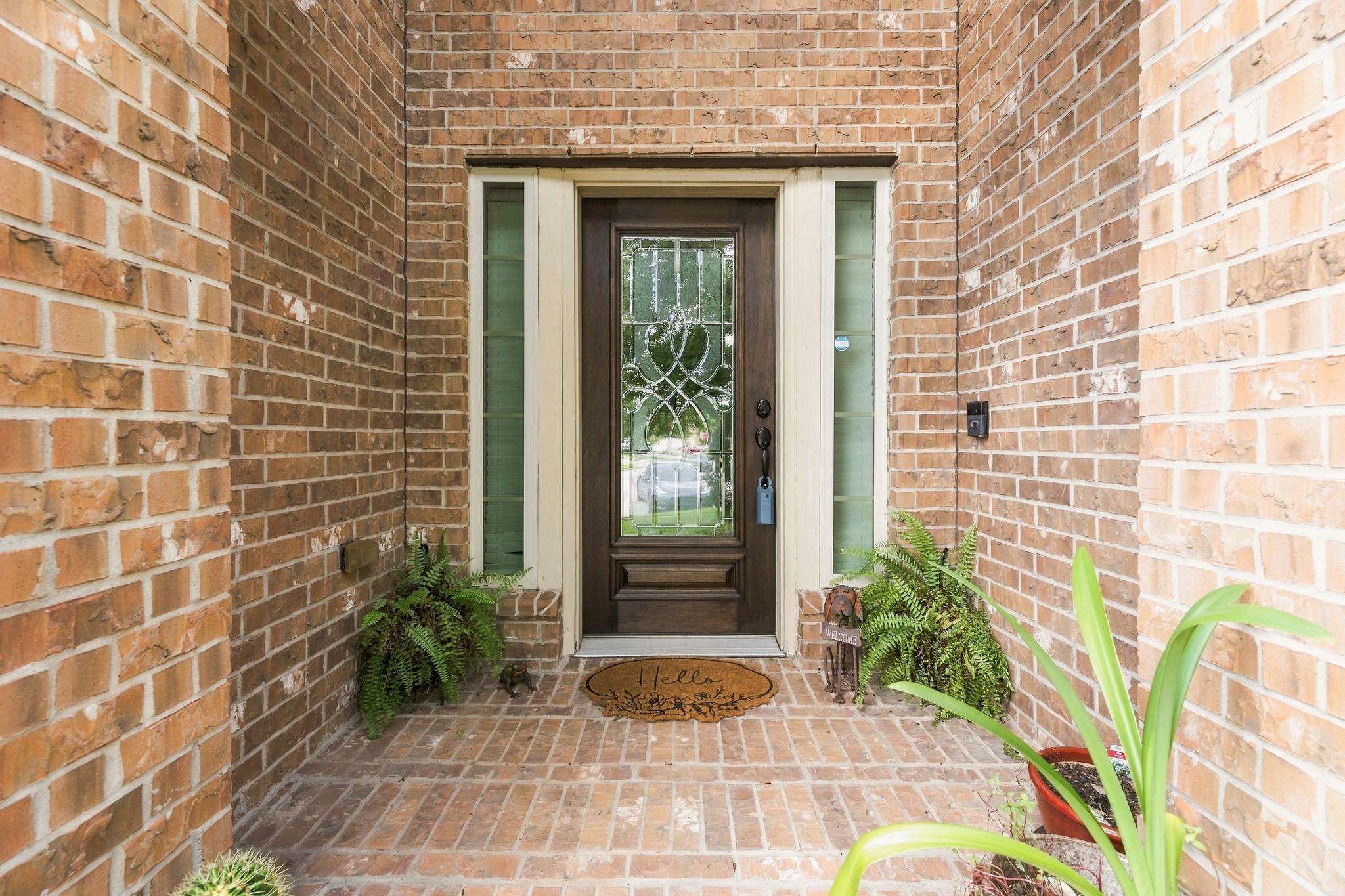 Image 3: Inviting covered front porch with elegant glass fr