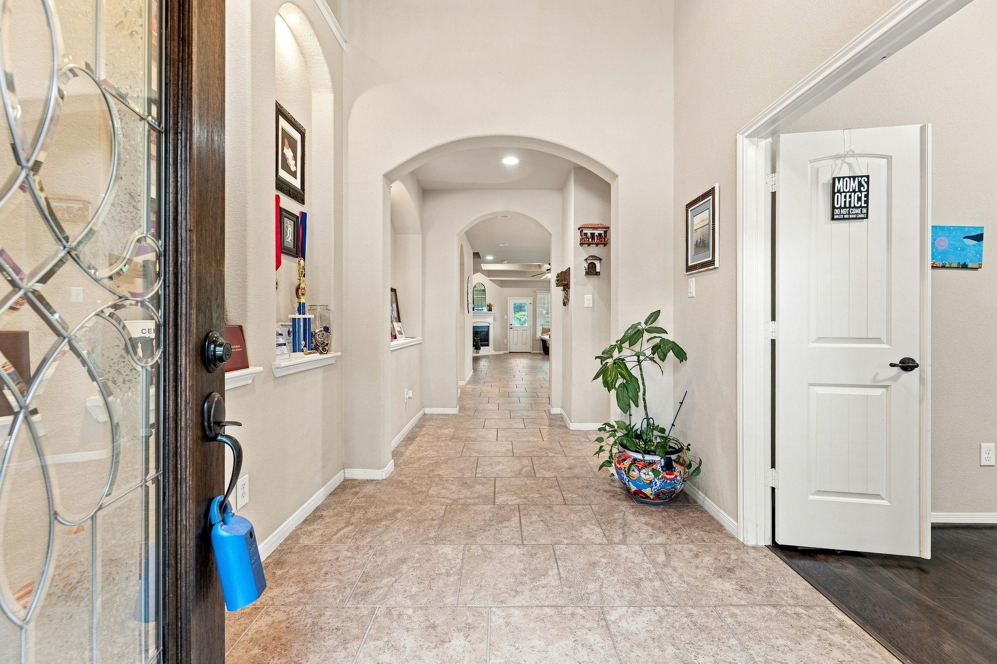 Image 4: Grand entry foyer featuring soaring ceilings, arch
