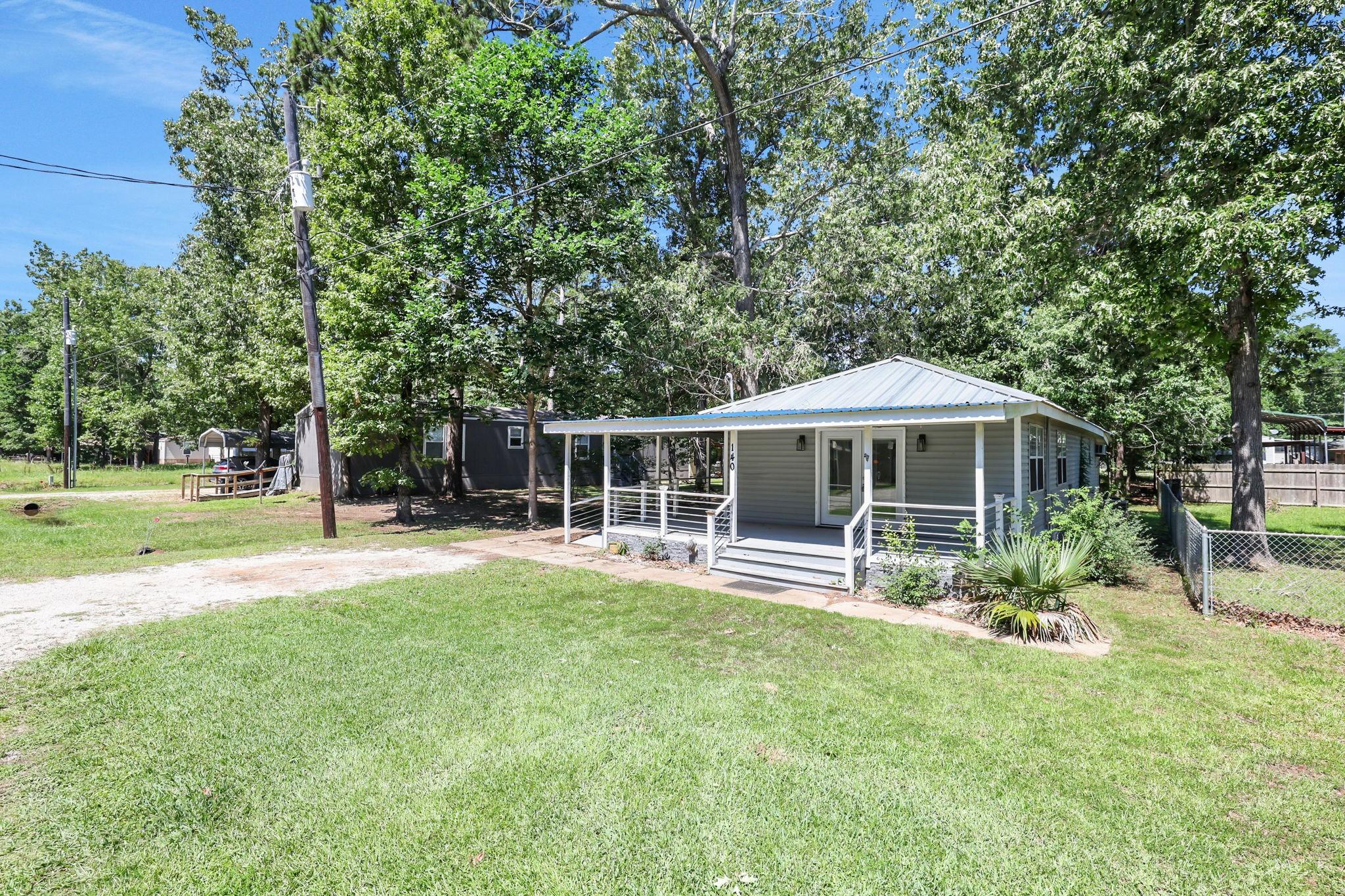 Image 2: The home sits on one lot with a nice driveway