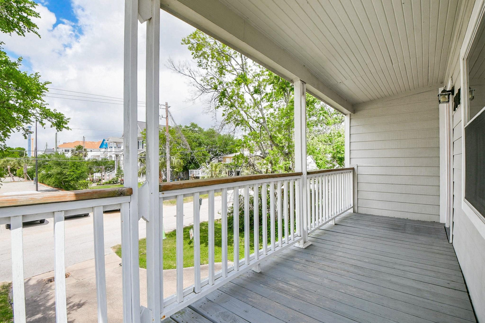 Image 3: This photo features a spacious, covered balcony wi