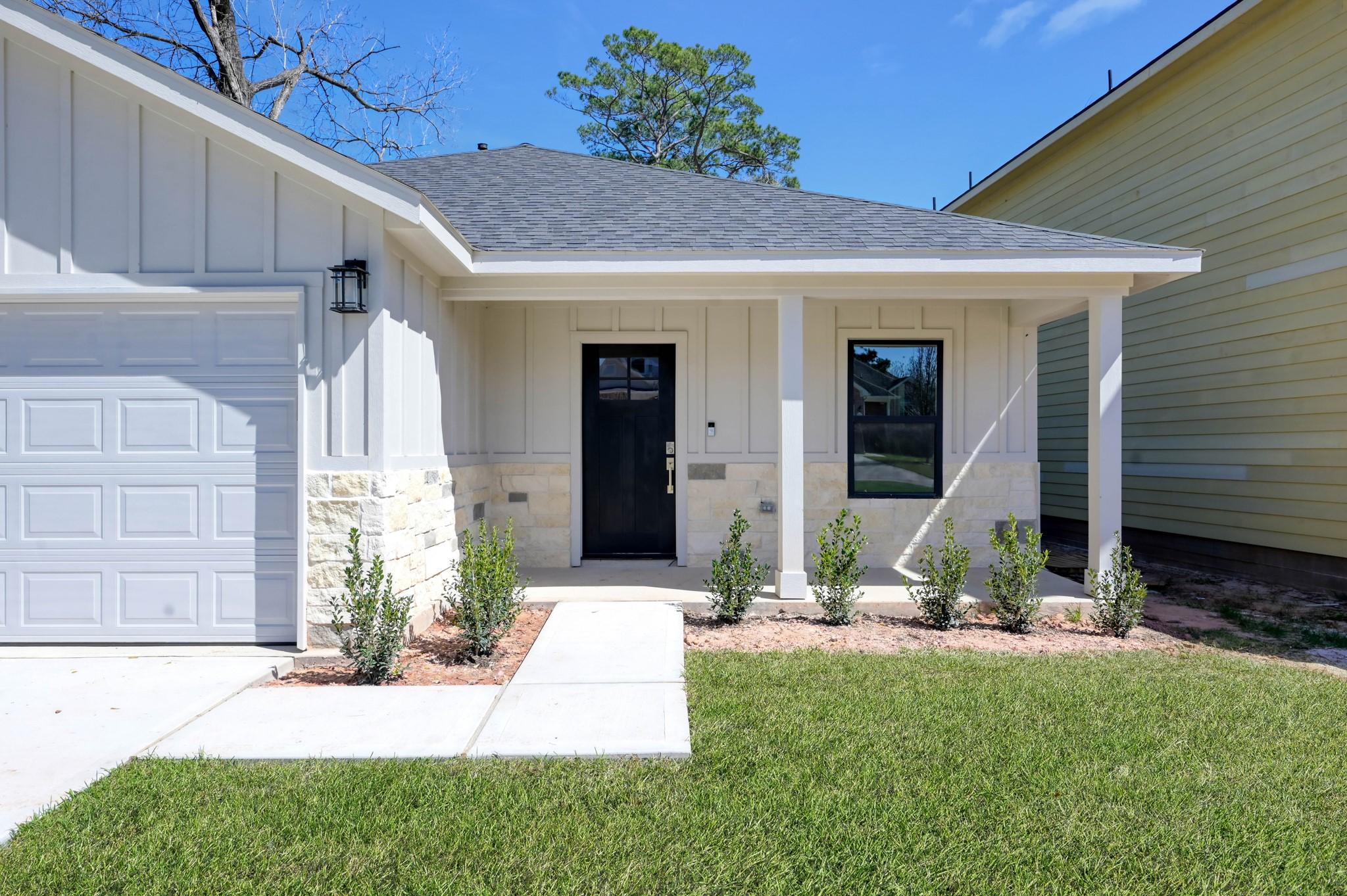 Image 3: A welcoming front porch with recessed lighting and