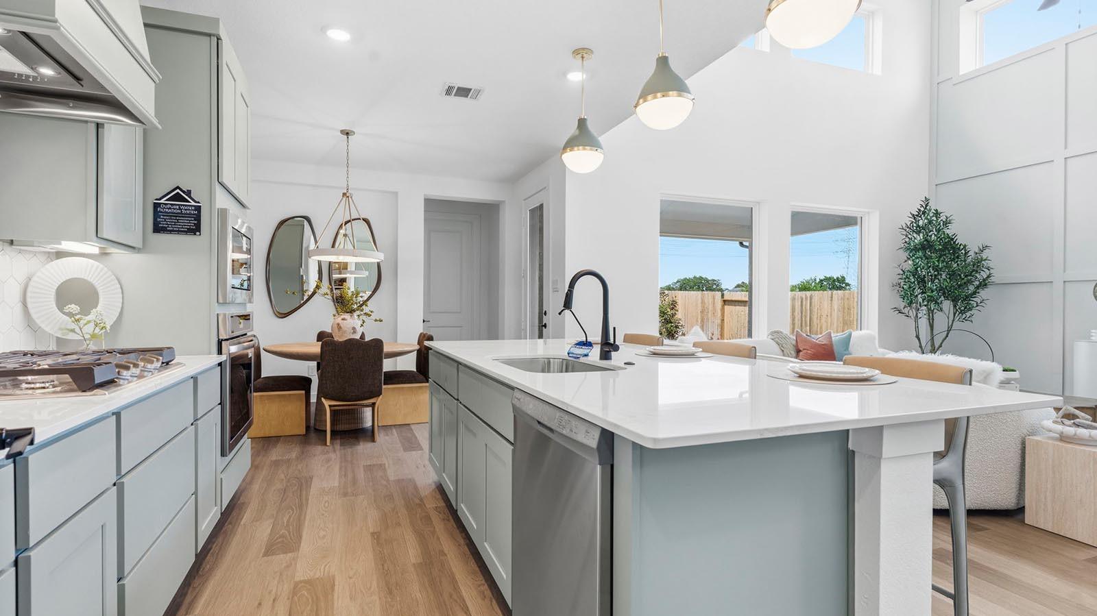 Image 2: An open concept kitchen with an island with bar se