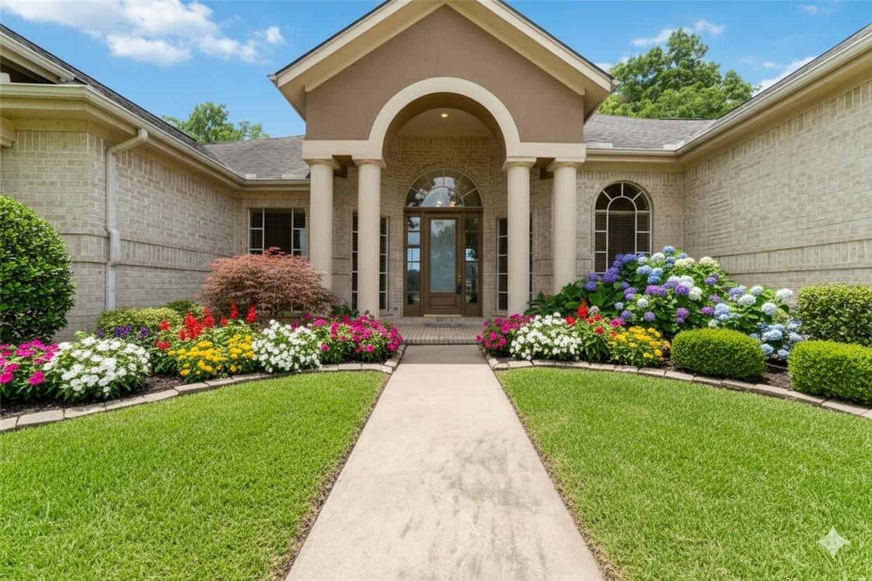 Image 1: This is a single-story brick home with an elegant