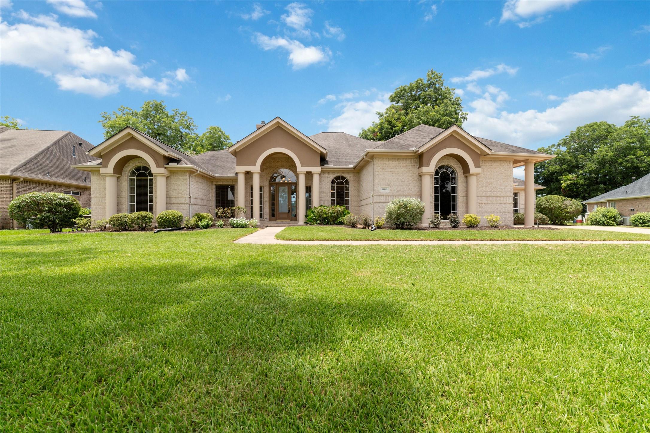 Image 3: This is a single-story home featuring a tan brick