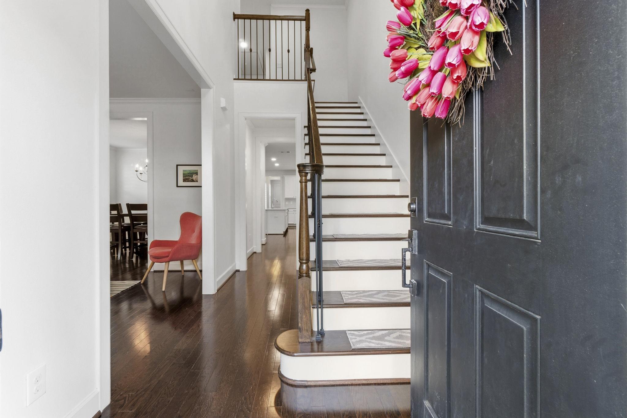 Image 4: Welcome to a bright entryway featuring timeless wo
