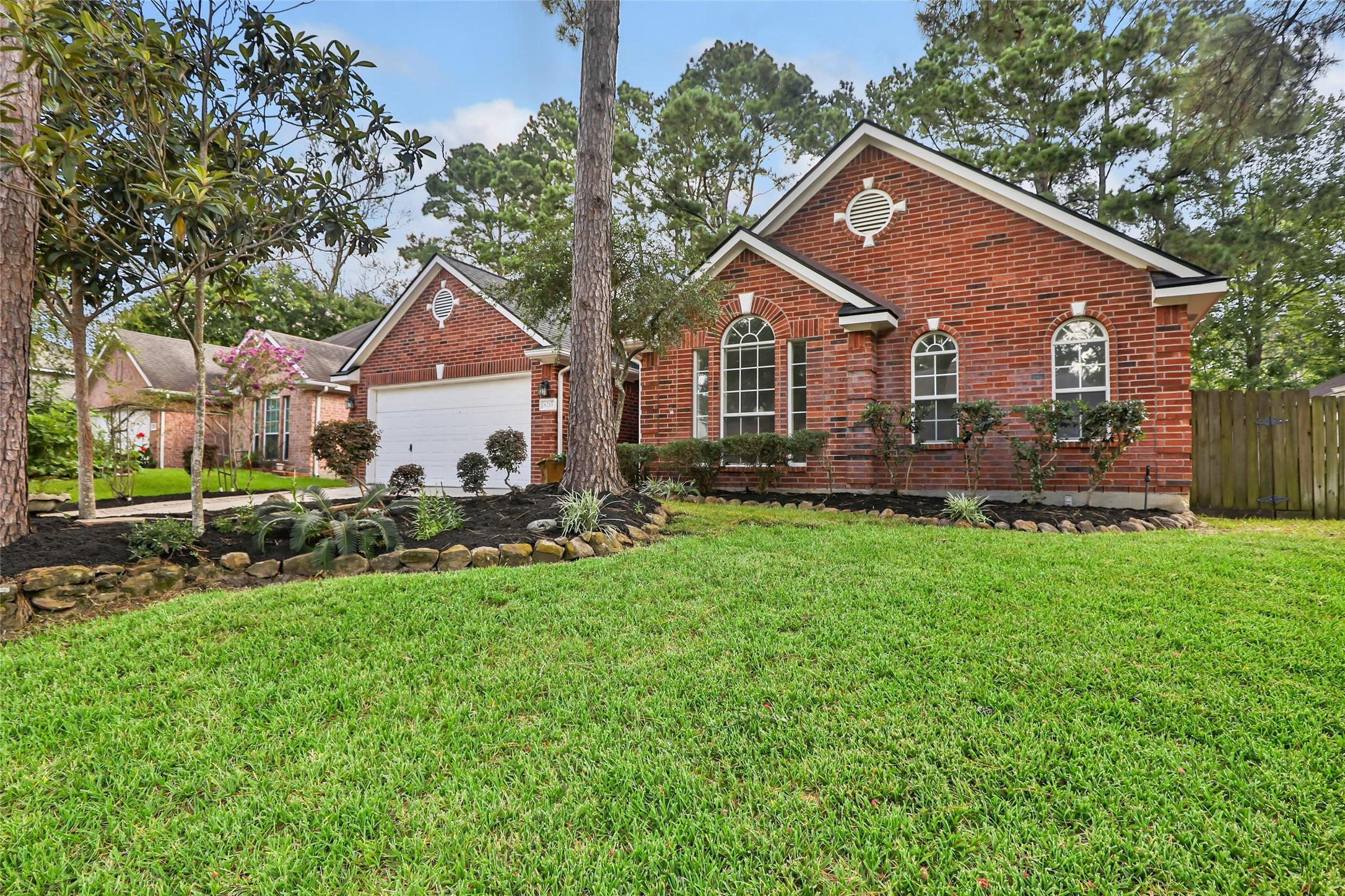 Image 2: A lovely view of the landscaped front  yard