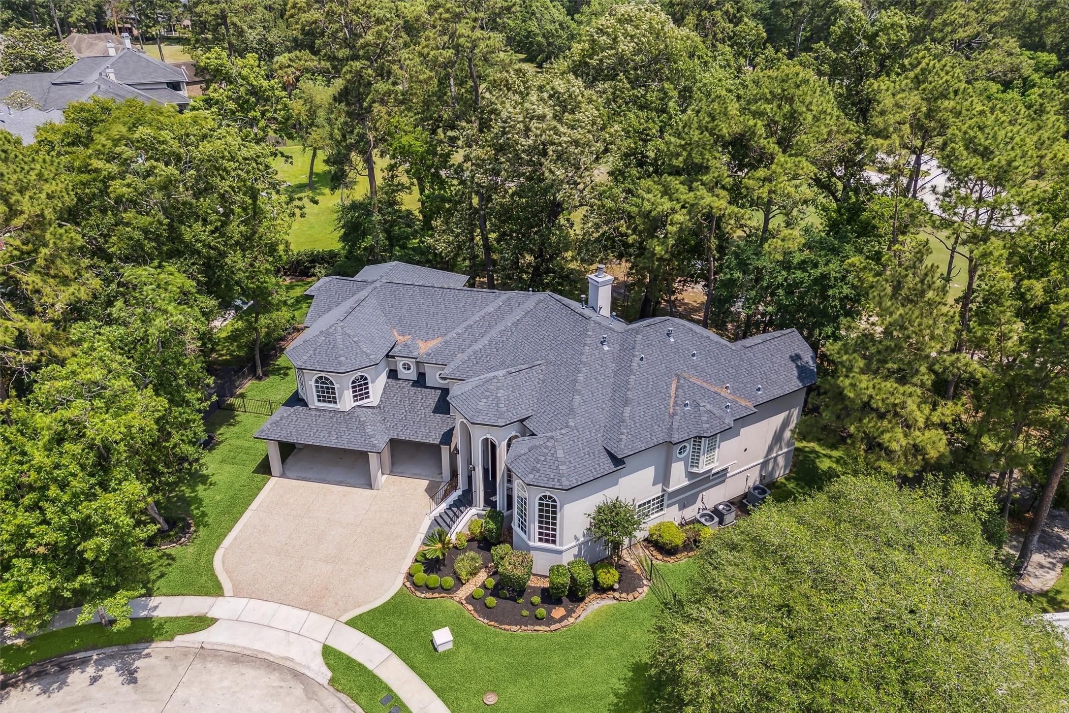 Image 4: Nestled in a wooded area, offering privacy and lus