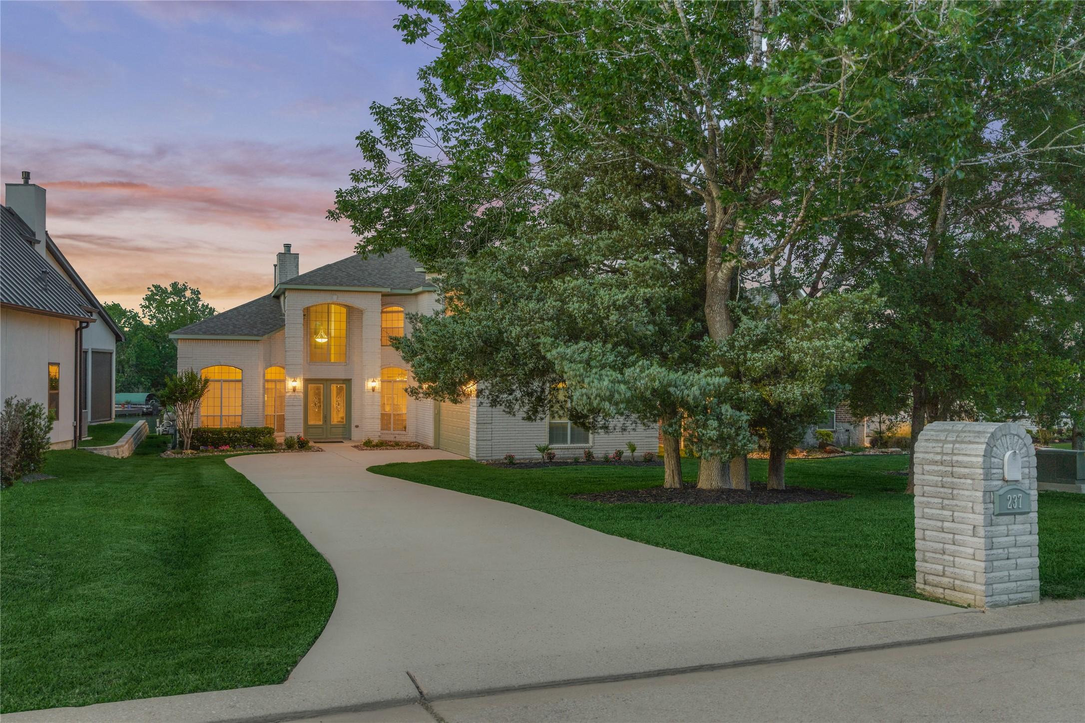 Image 4: A stately brick exterior paired with a striking tw