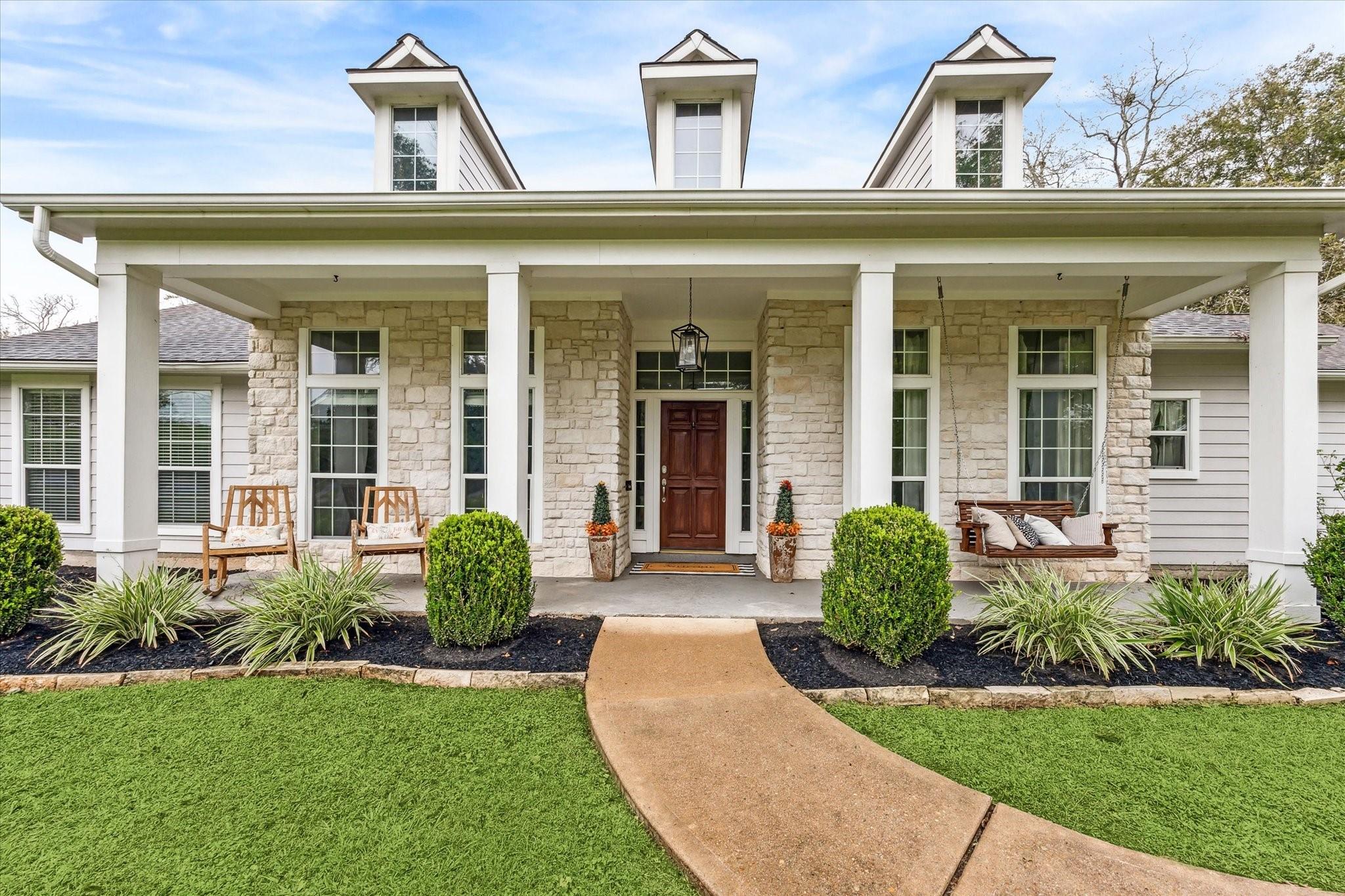 Image 2: The full front pillared porch has plenty of room f