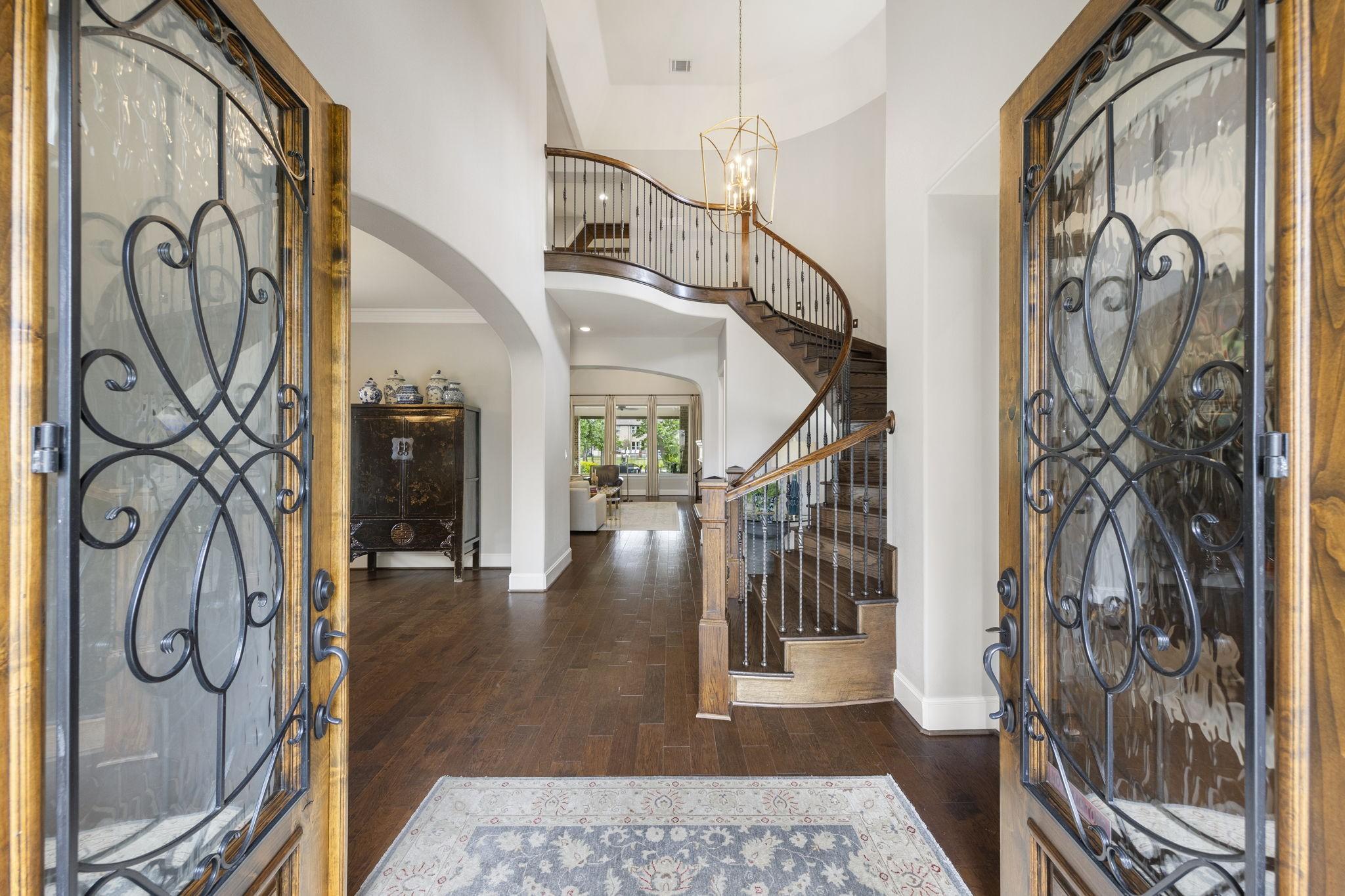 Image 4: Grand entry with double iron and glass doors openi
