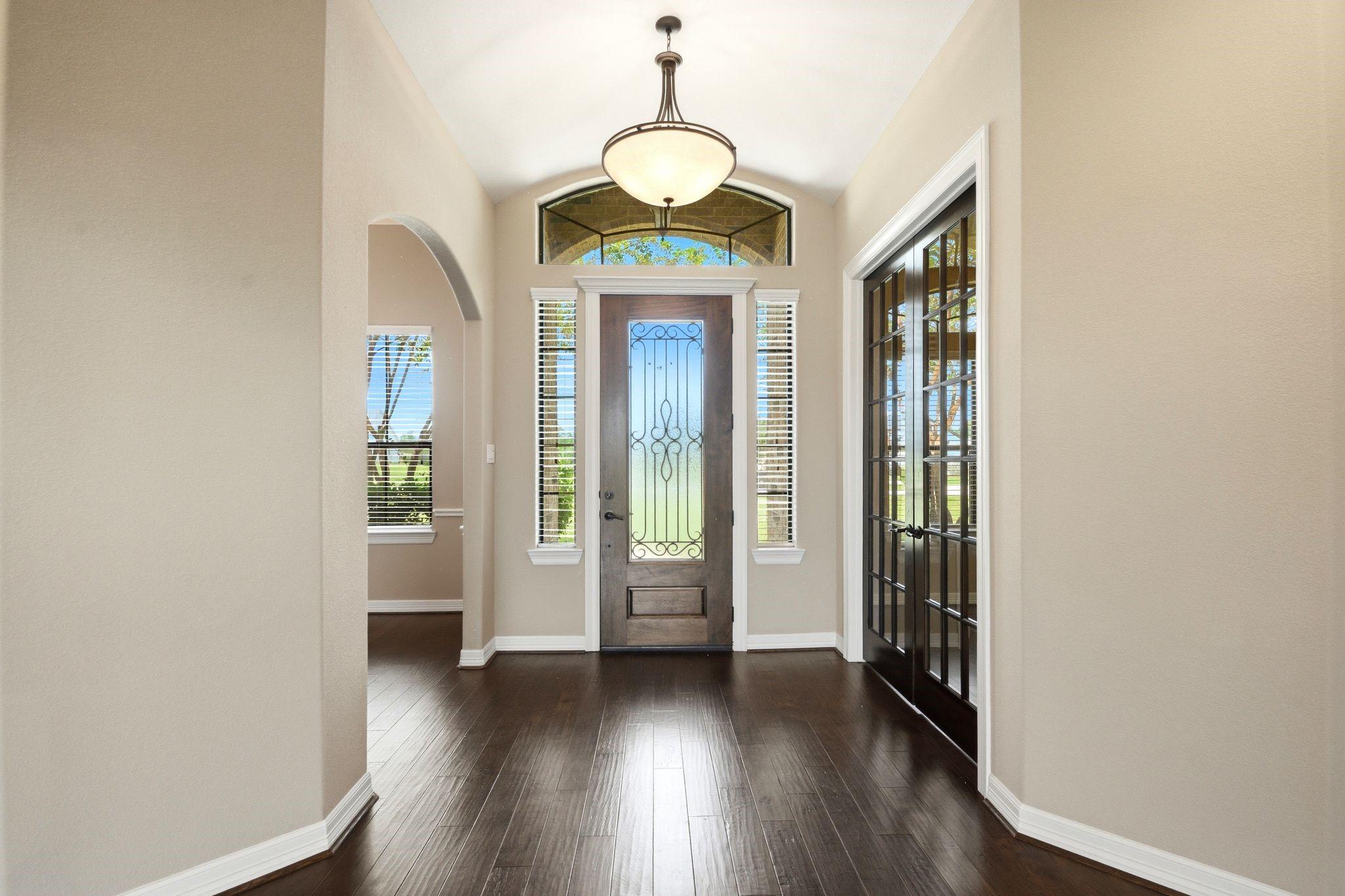Image 3: Elegant entryway with a beautiful wooden door feat
