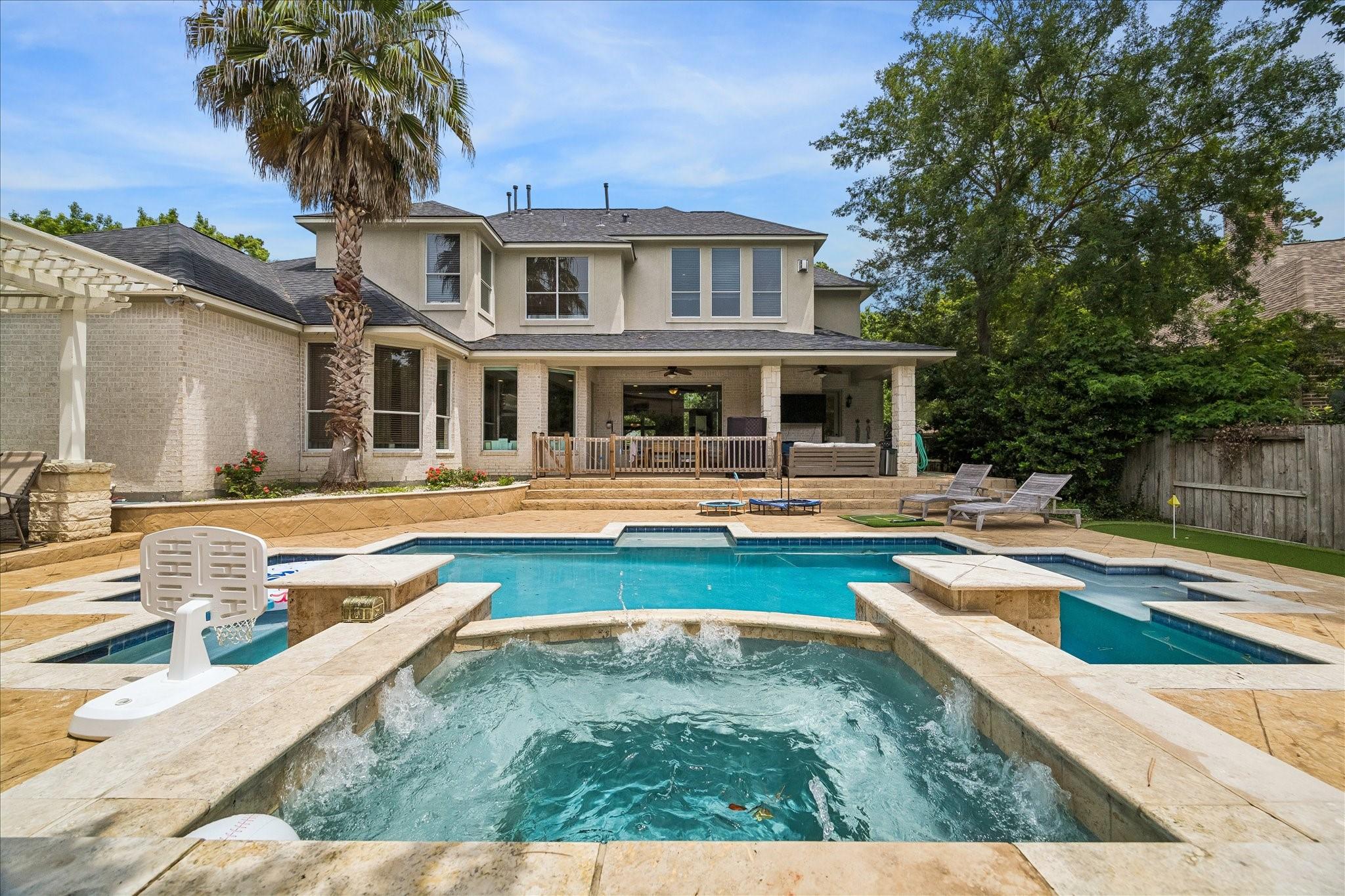 Image 1: Resort style backyard featuring a raised spa that