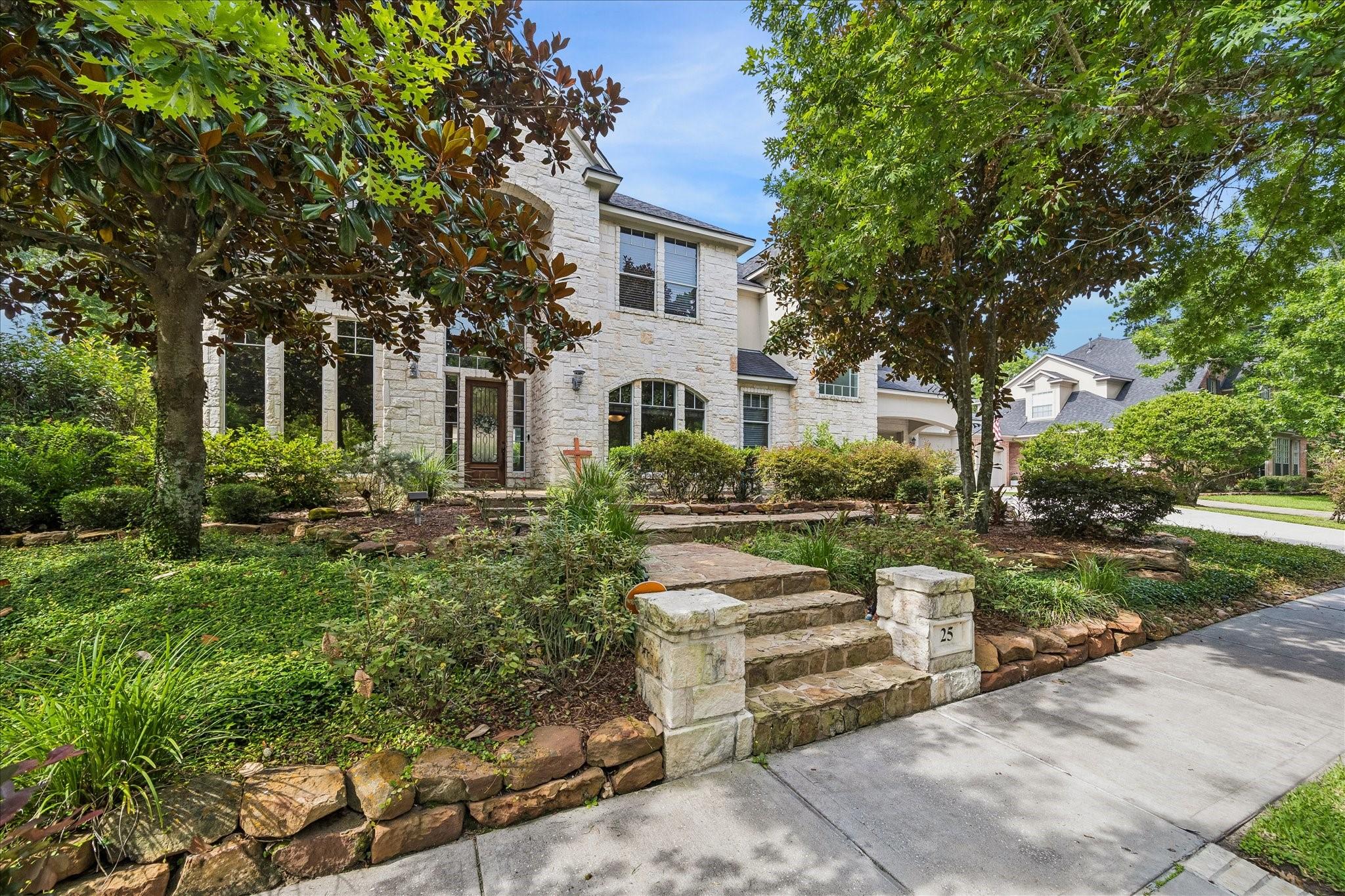 Image 2: The stately stone exterior, soaring two story entr