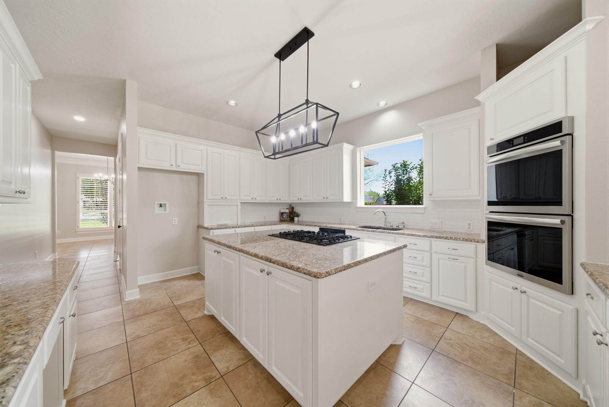 Image 3: Bright and open chef&rsquo;s kitchen featuring granite c