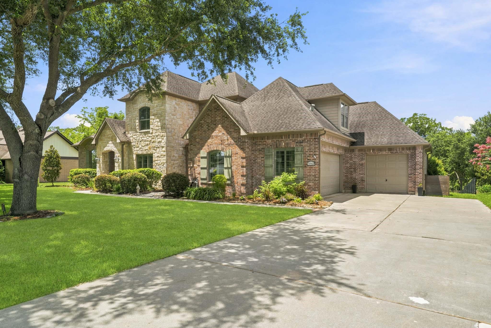Image 2: The expansive driveway and oversized three-car gar