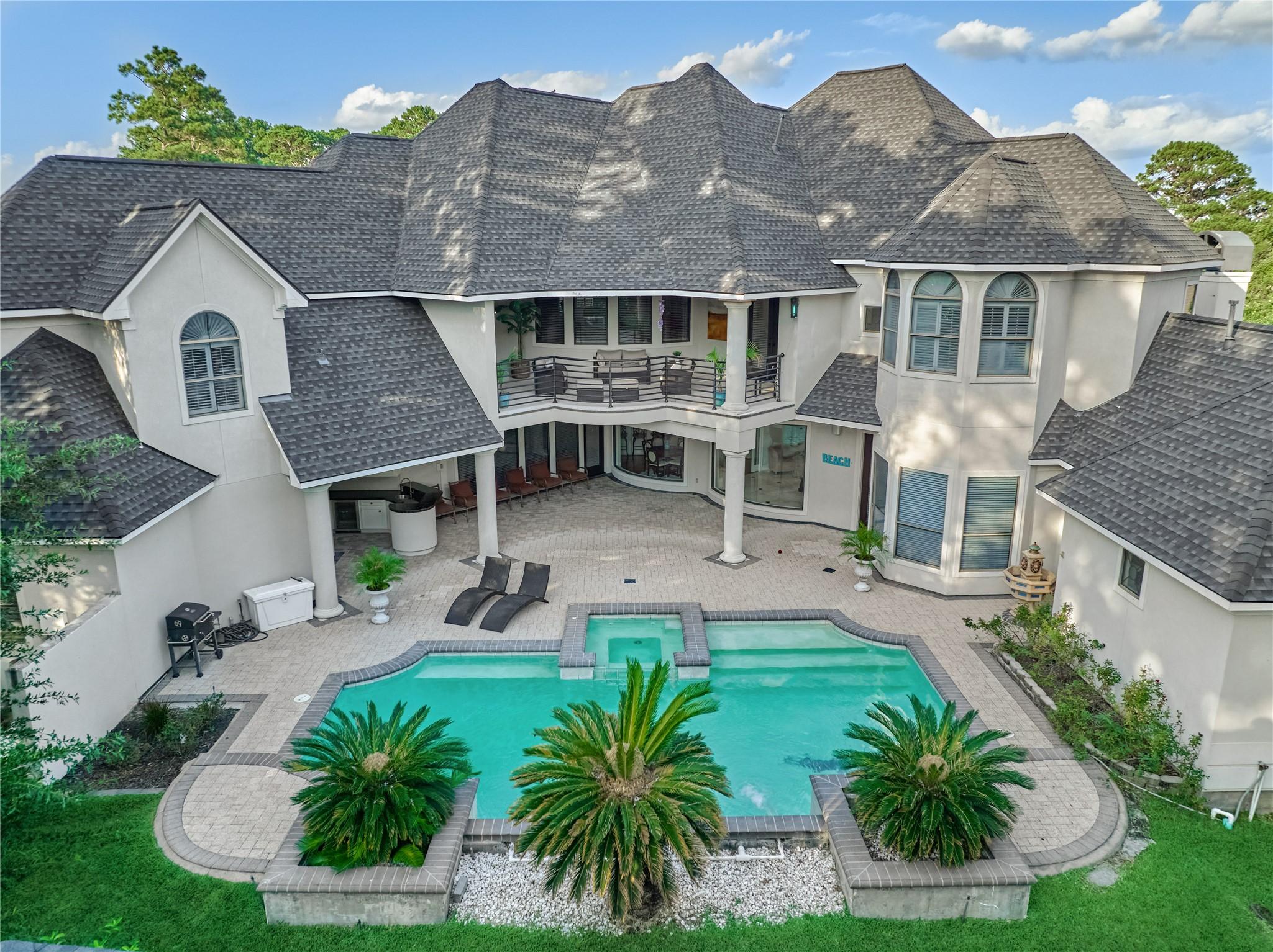 Image 2: The resort-style backyard is spectacular! The pool