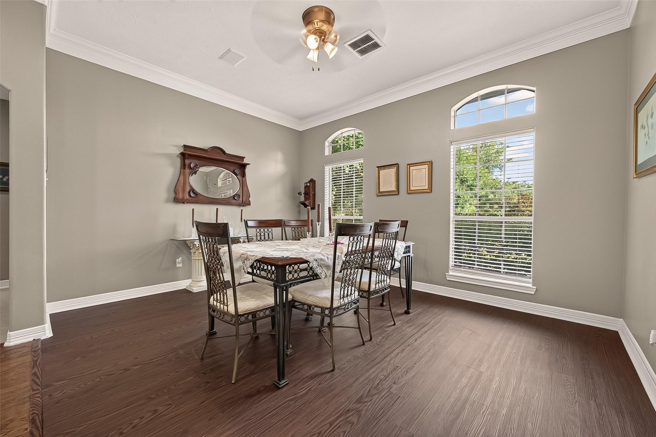 Image 4: The formal dining room offers vinyl flooring.