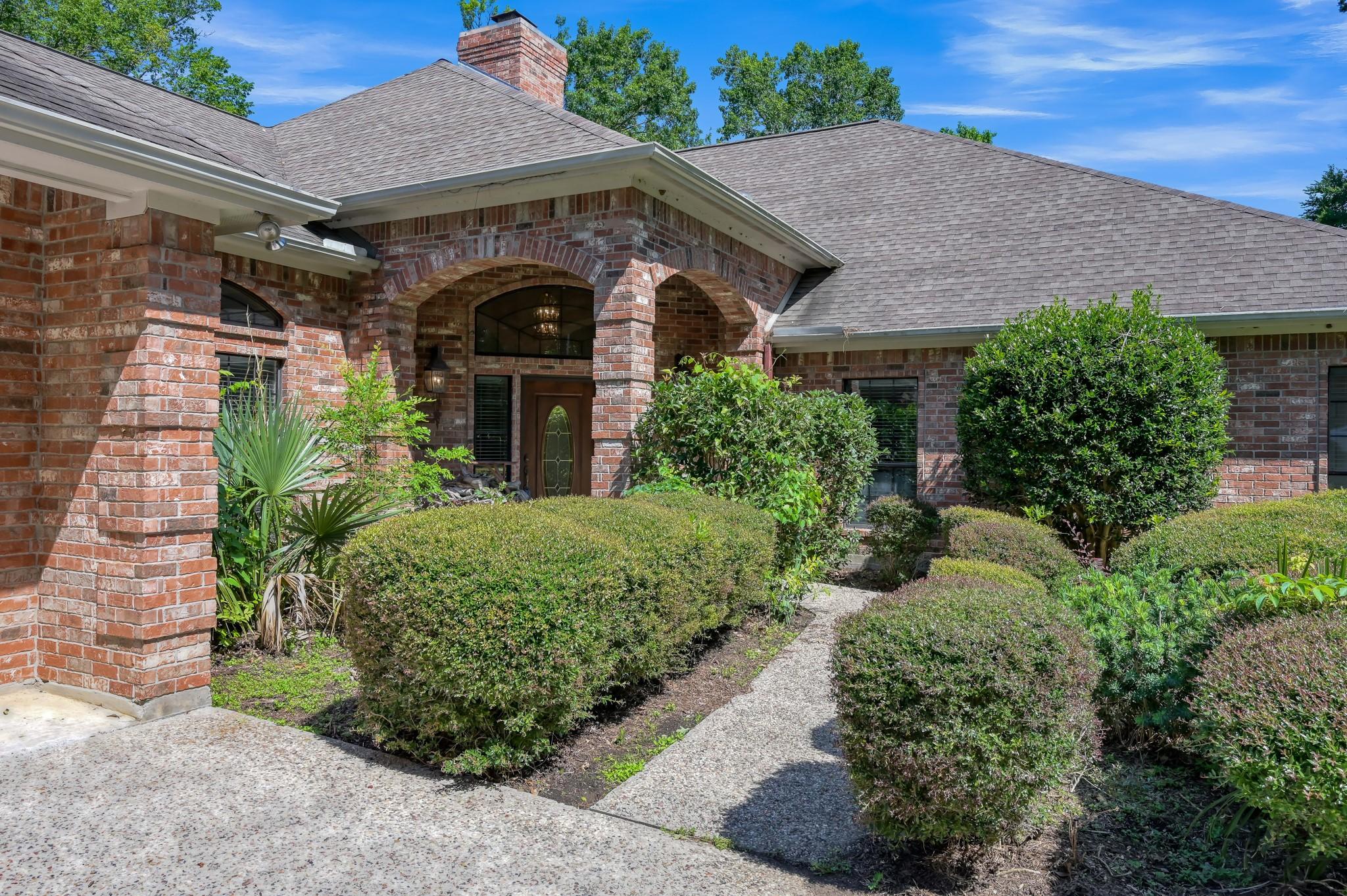 Image 4: This beautiful brick home features a welcoming fro
