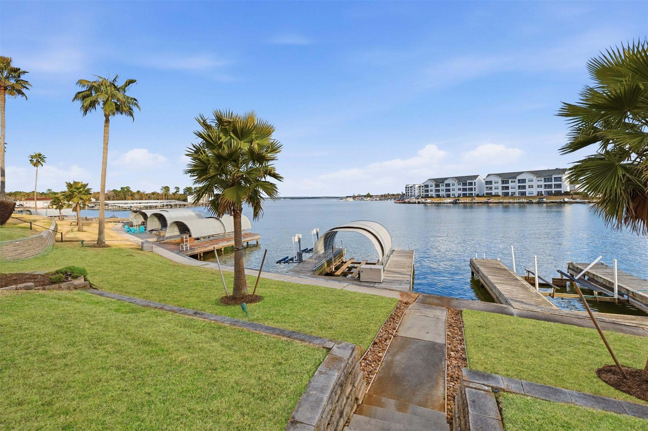 Image 3: Covered boat slip, lift, and 2 jet ski lifts...