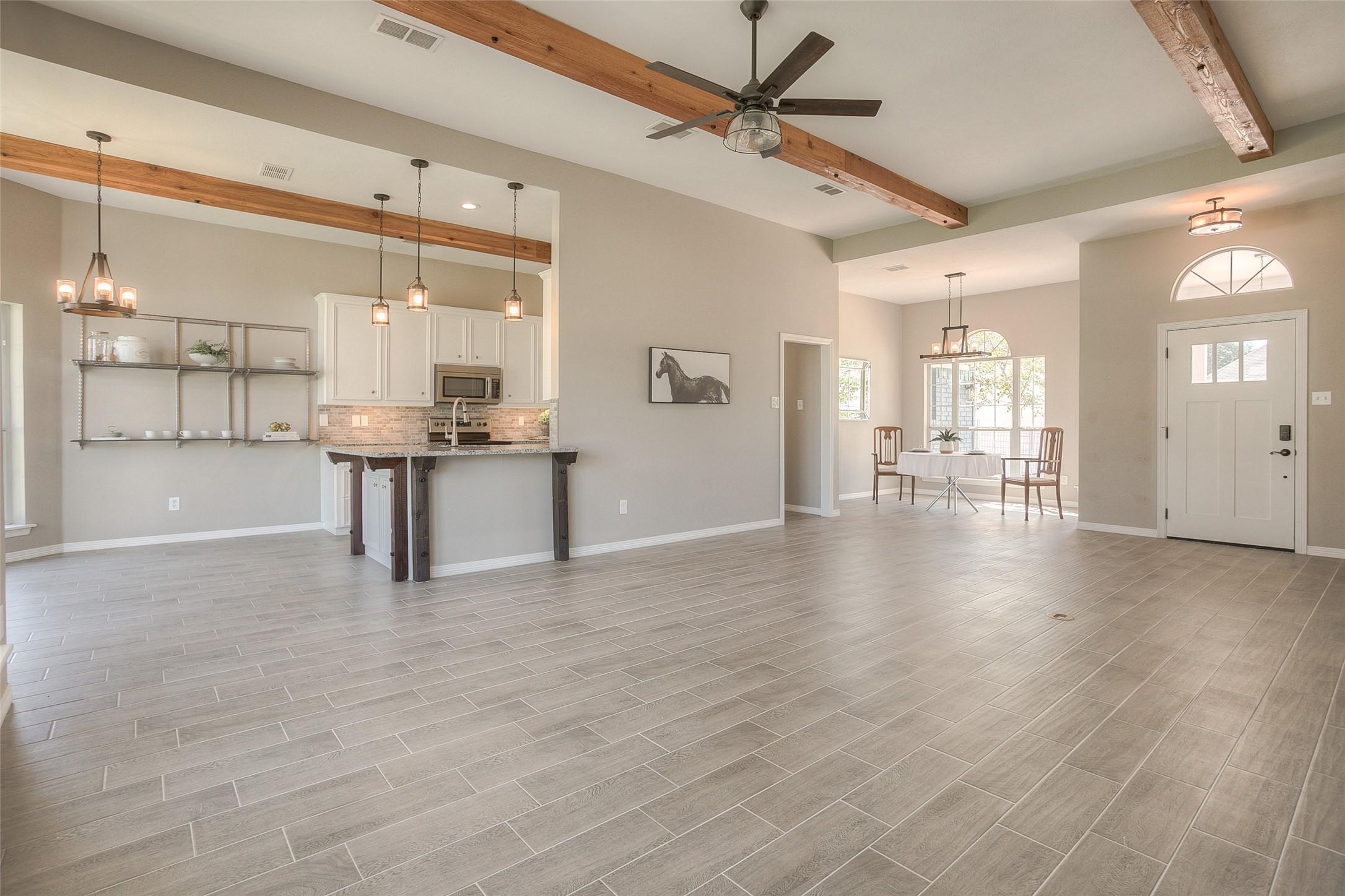 Image 3: Open living/dining/kitchen/breakfast area.