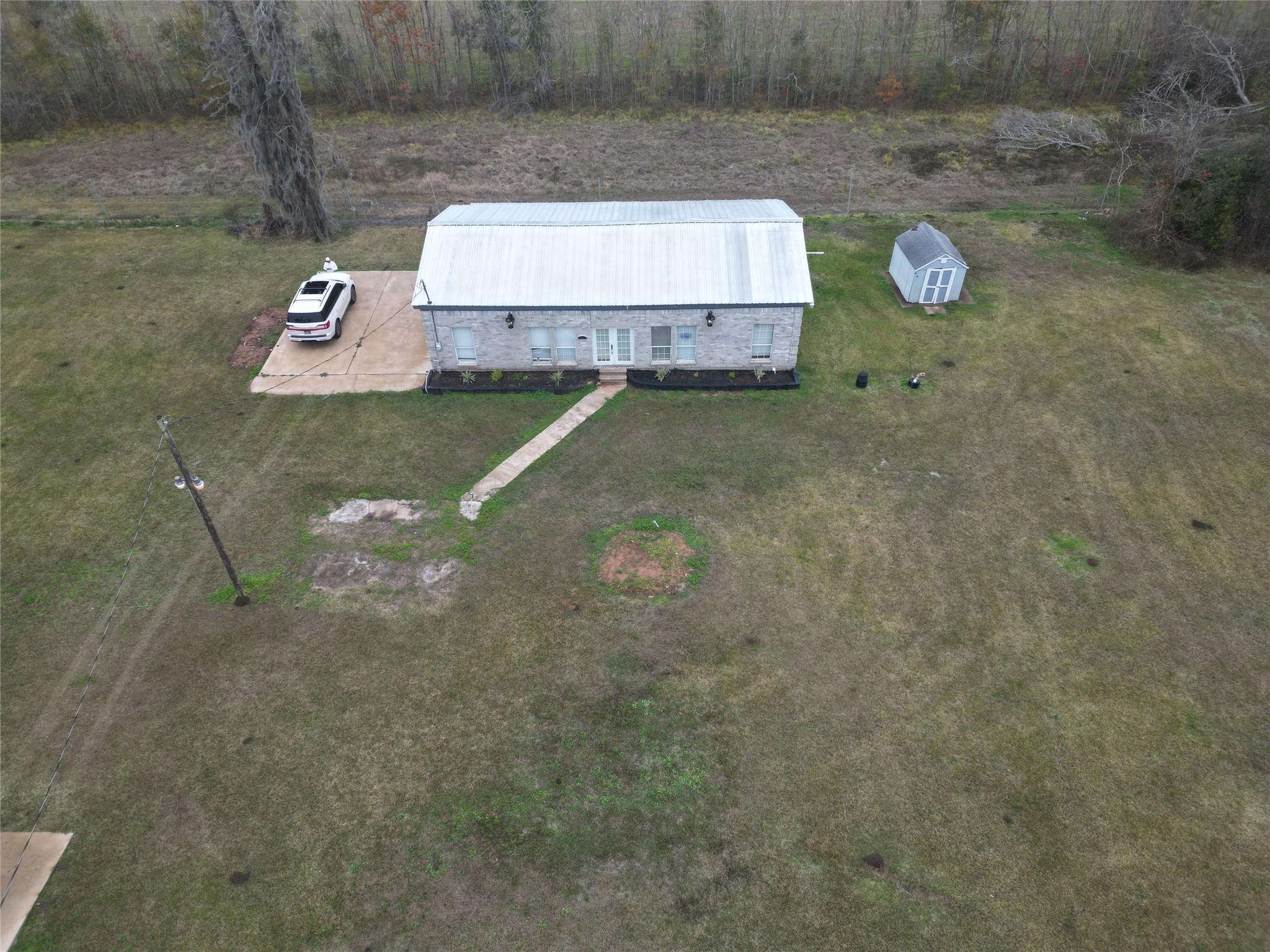 Image 1: Drone view from the front of the house.