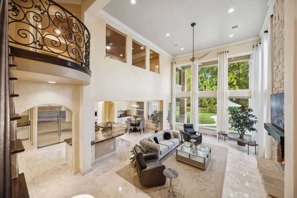 Image 2: This stunning living room features a grand, open-c