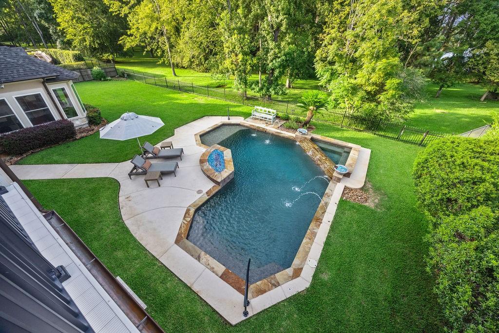 Image 3: A beautiful backyard with a uniquely shaped pool s