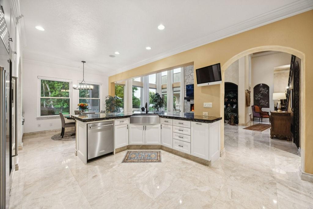 Image 4: A spacious, modern kitchen with elegant white cabi