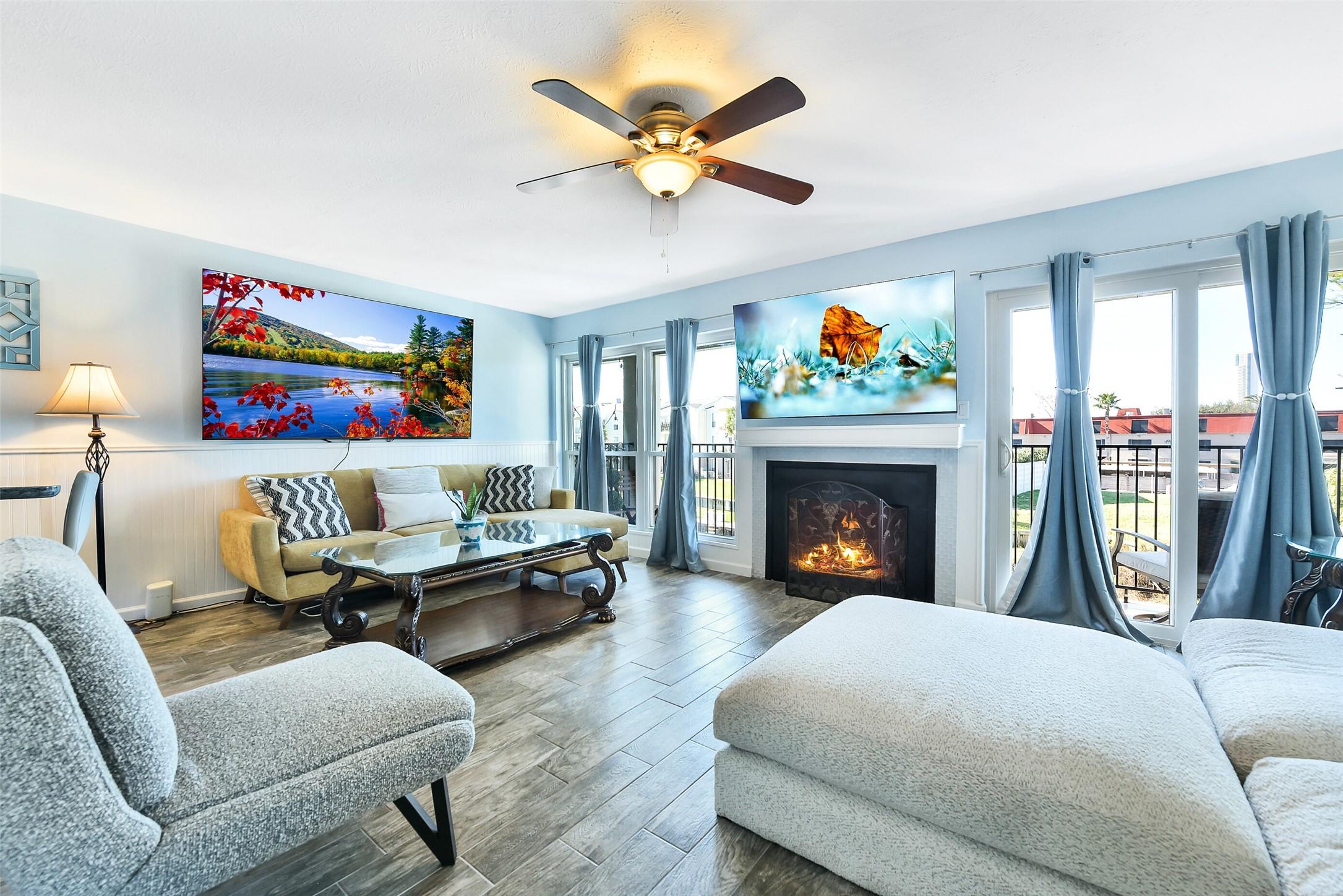 Image 3: Living area with fireplace and natural light conne