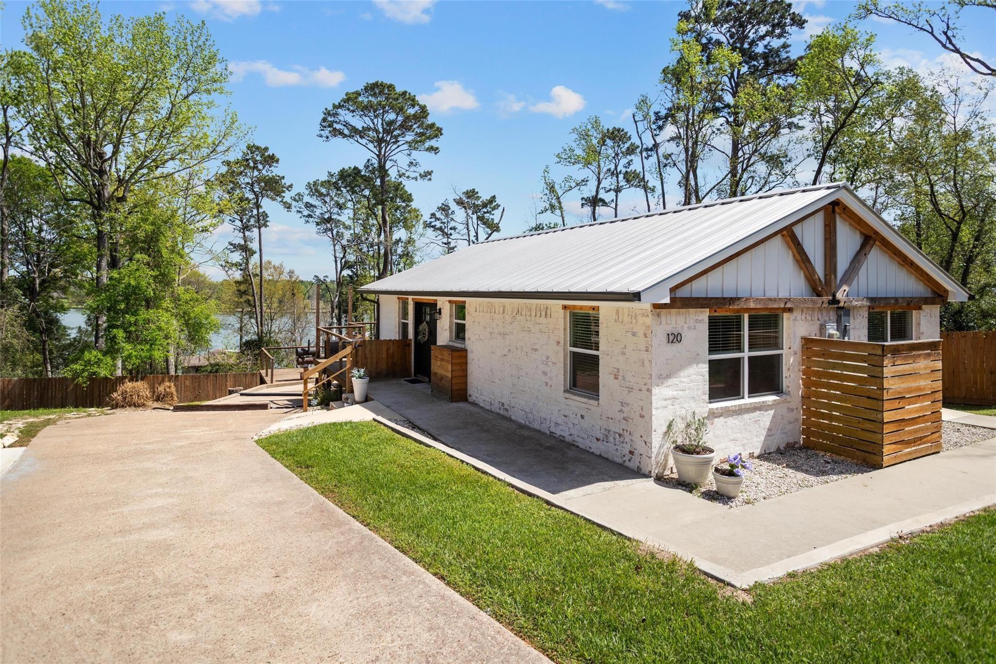 Image 1: Front of home sitting on a high elevation with won