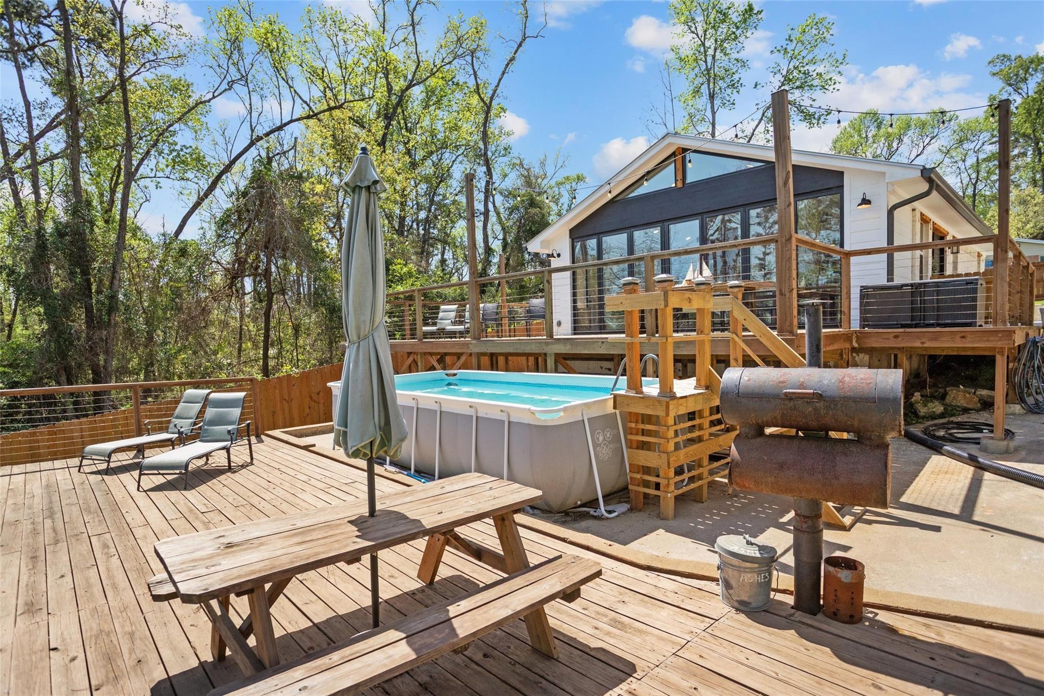 Image 3: Another extended patio with an above ground pool f