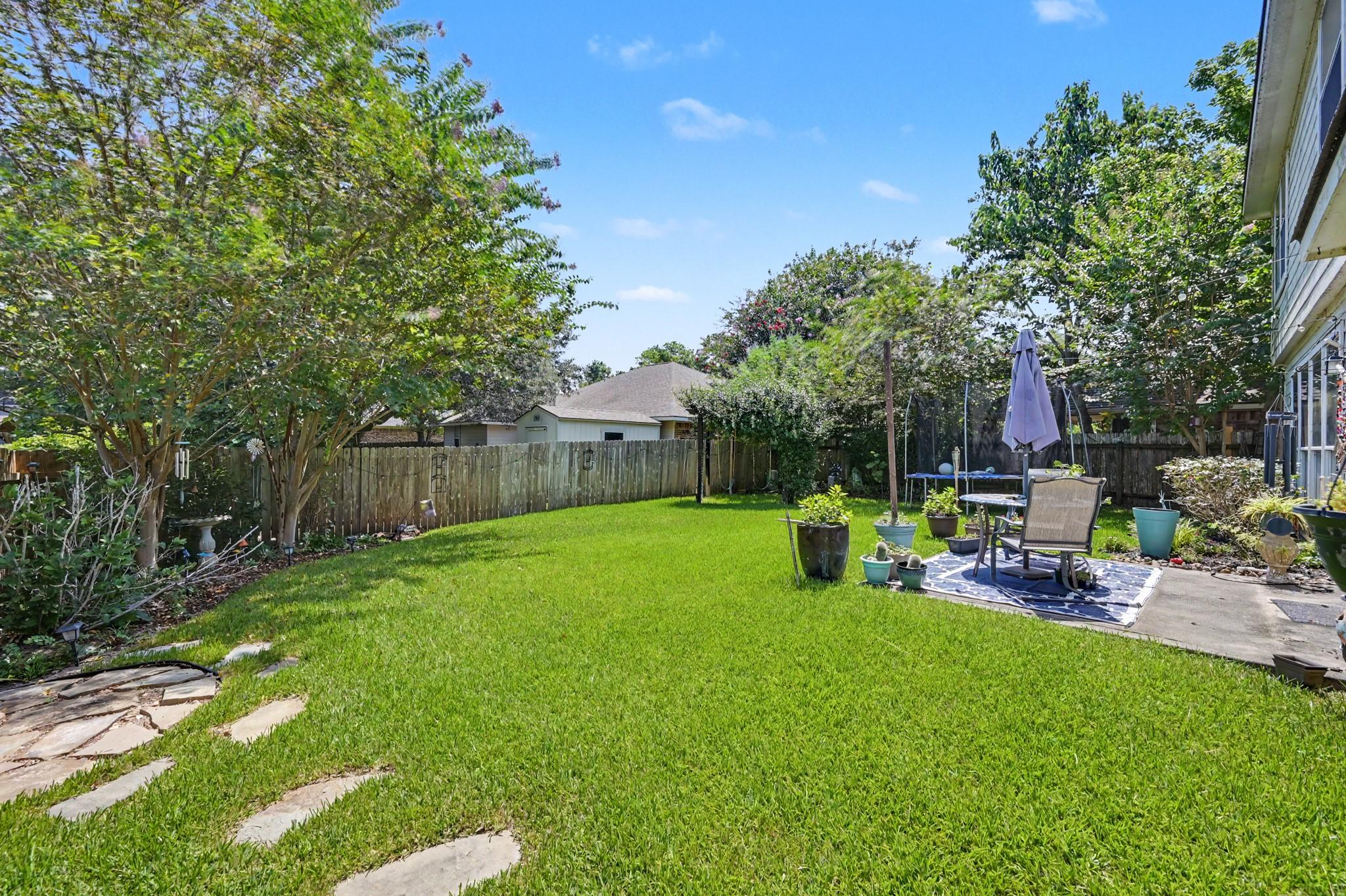 Image 3: Totally fenced backyard with concrete patio area