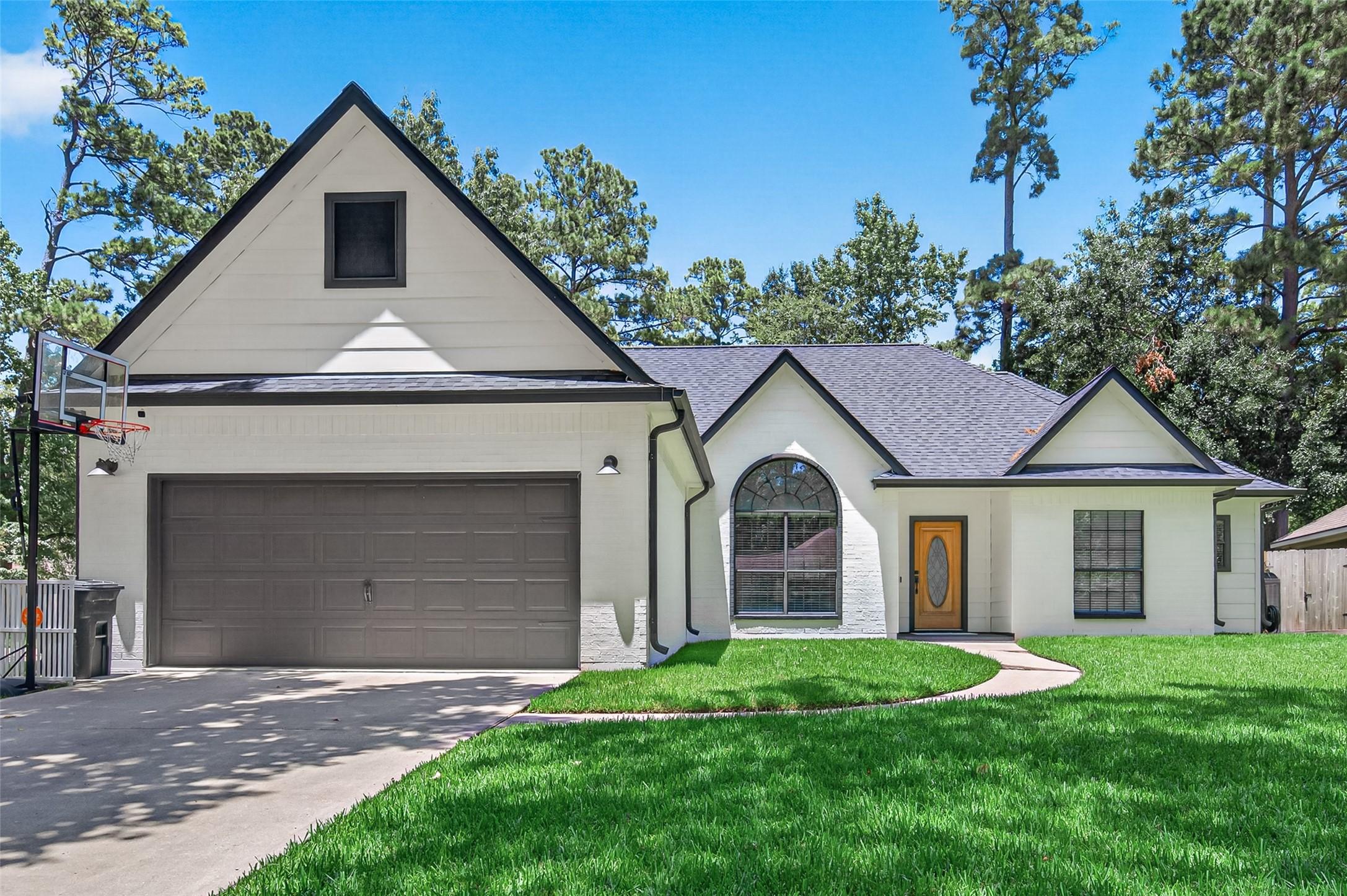 Image 1: Charming home with a classic gable roof, two-car o