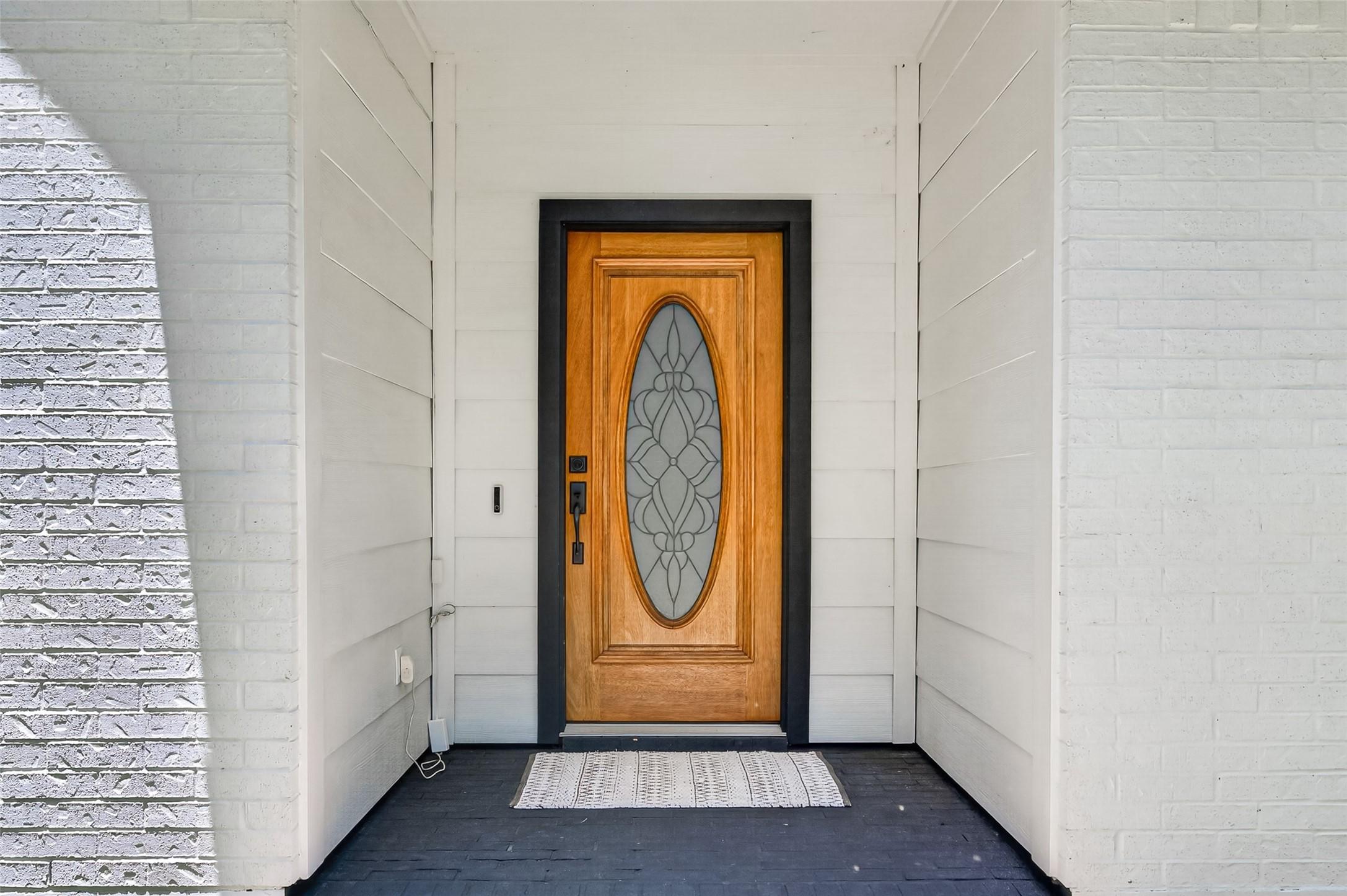 Image 3: Entryway featuring a beautiful wooden door with de