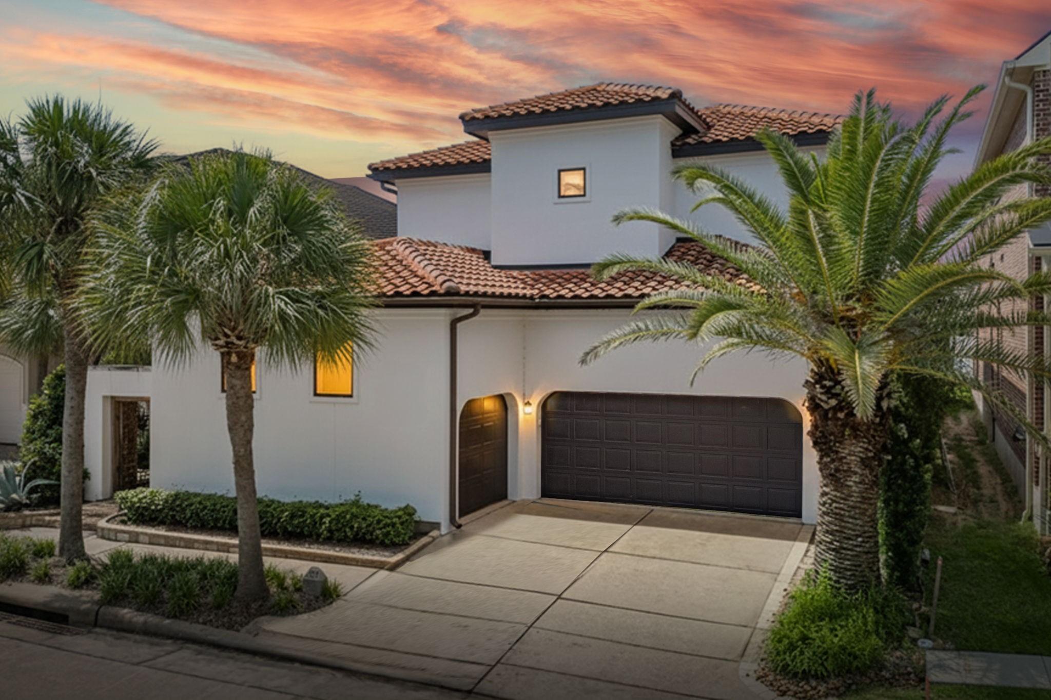 Image 2: Mediterranean-style stucco home with a classic til