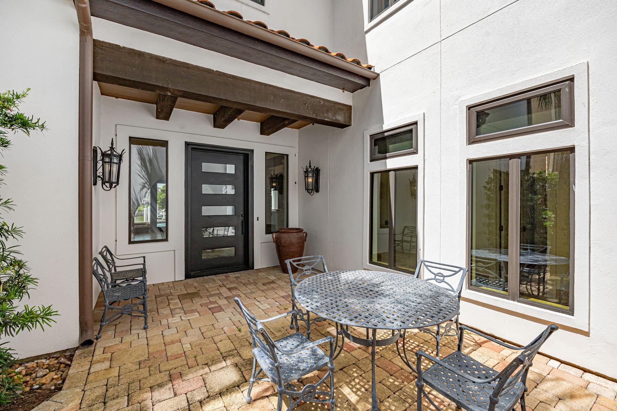 Image 4: A secure steel entry door opens to a welcoming pat
