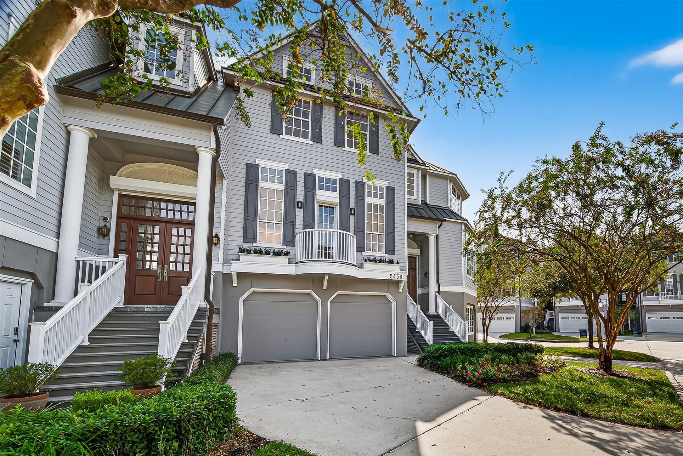 Image 2: Front elevation of the townhome. 2 car garage with