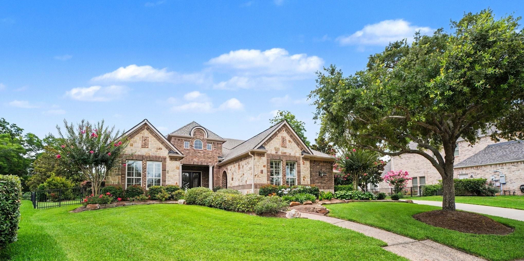 Image 2: This photo showcases a charming brick home with a
