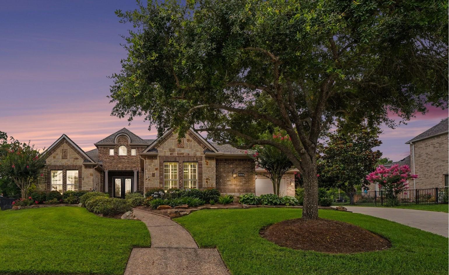 Image 3: This charming home features a beautiful brick faca