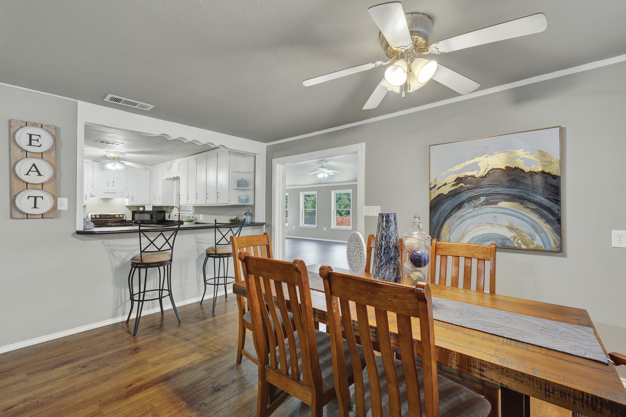 Image 4: Inviting dinning Room. The space flows into a sunl