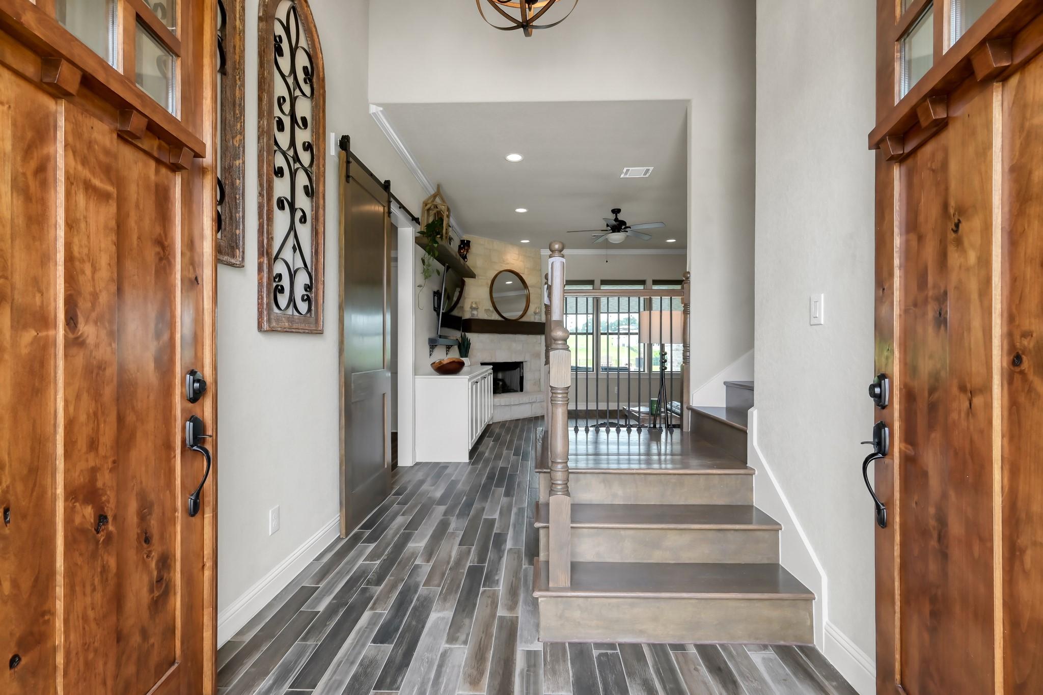 Image 2: Welcome to a charming entryway with rich wooden do