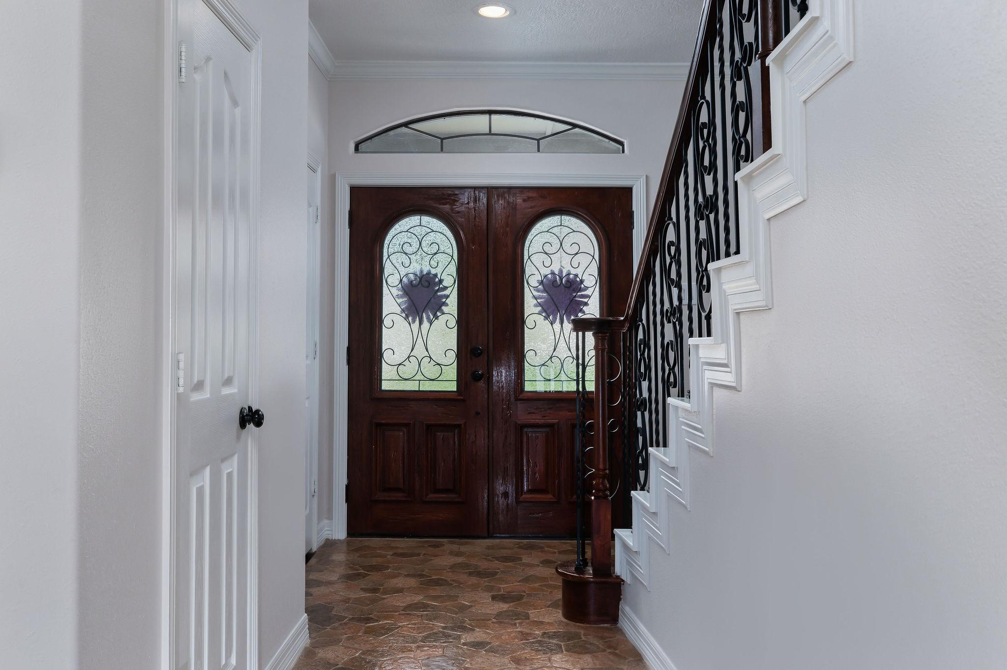 Image 3: Custom double doors lead into the home/foyer.