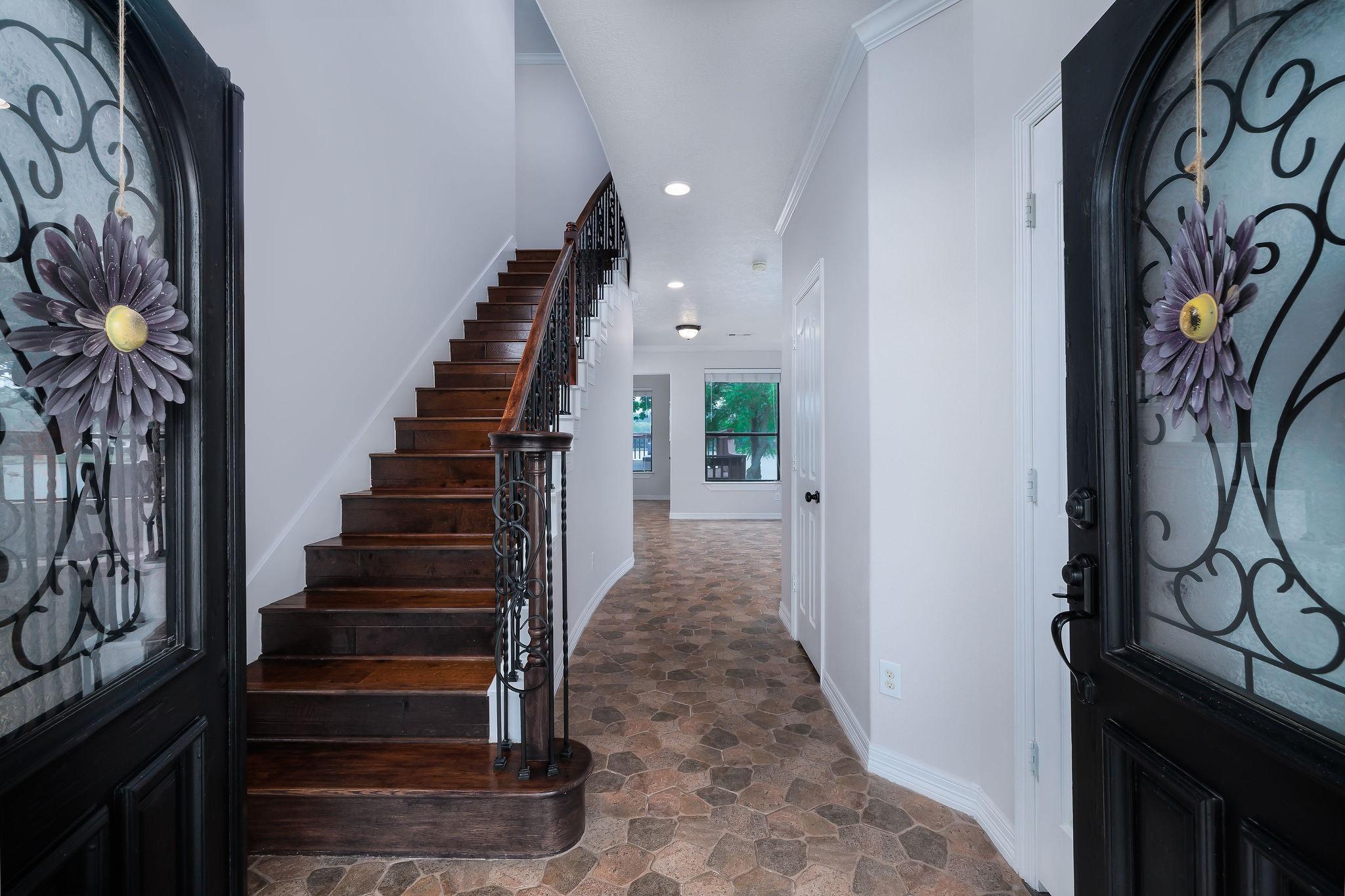 Image 4: Looking into the home/foyer and custom staircase f