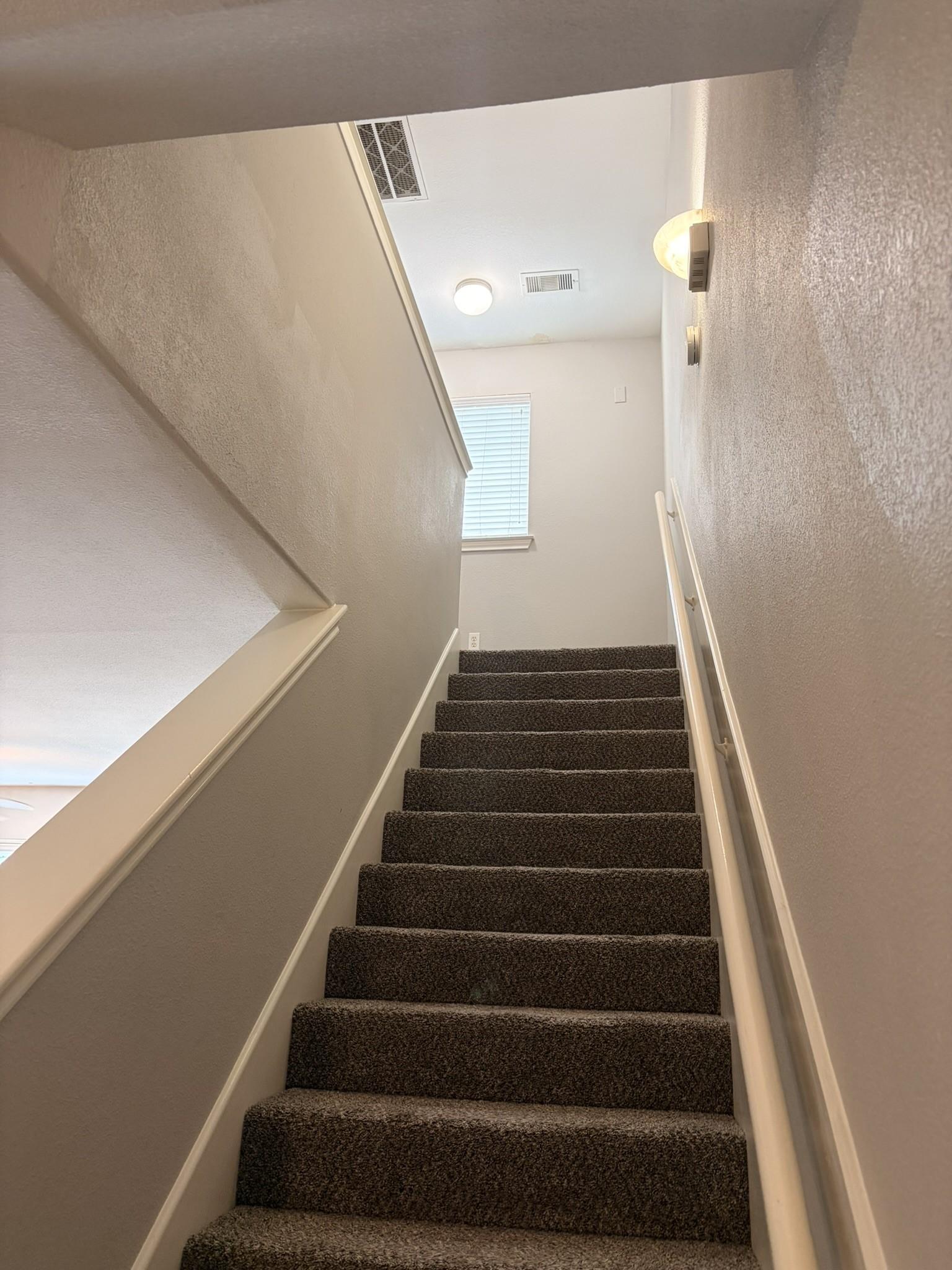 Image 2: 2 stair cases inside home.