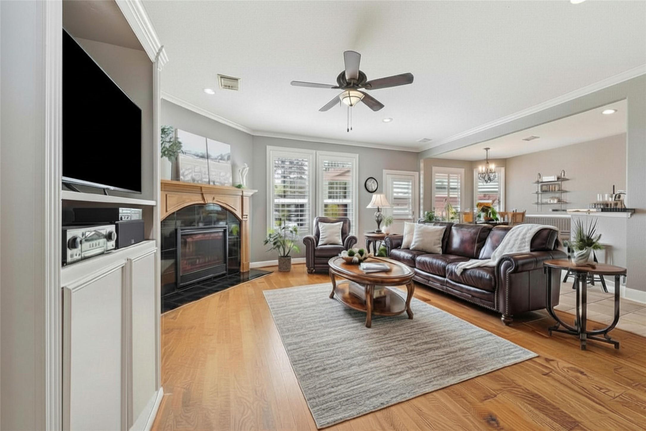 Image 3: Family room with beautiful wood floors and cozy fi
