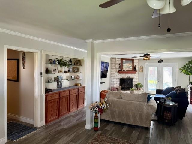 Image 3: Spacious living area featuring a cozy brick firepl