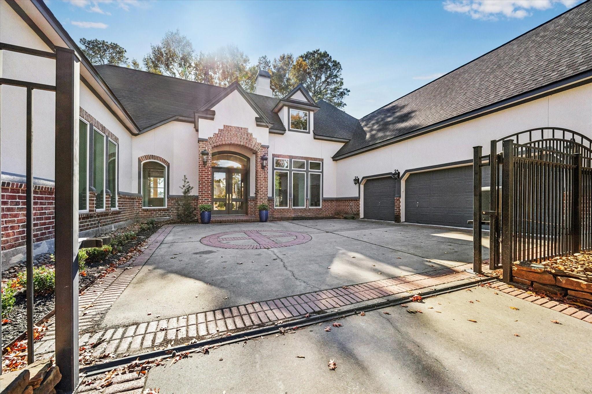 Image 3: From the front, a stately iron gated drive guides