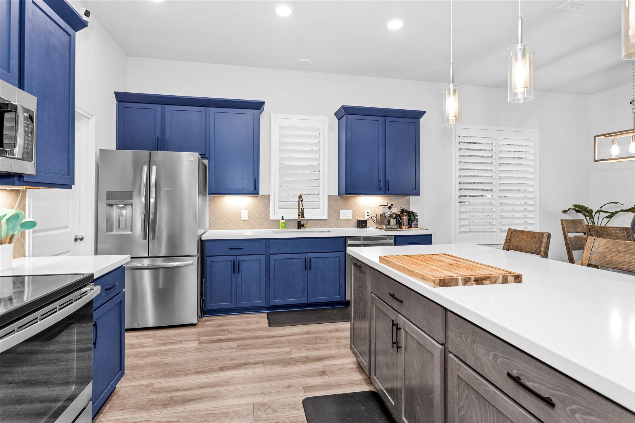 Image 4: Well-appointed island kitchen with quartz countert